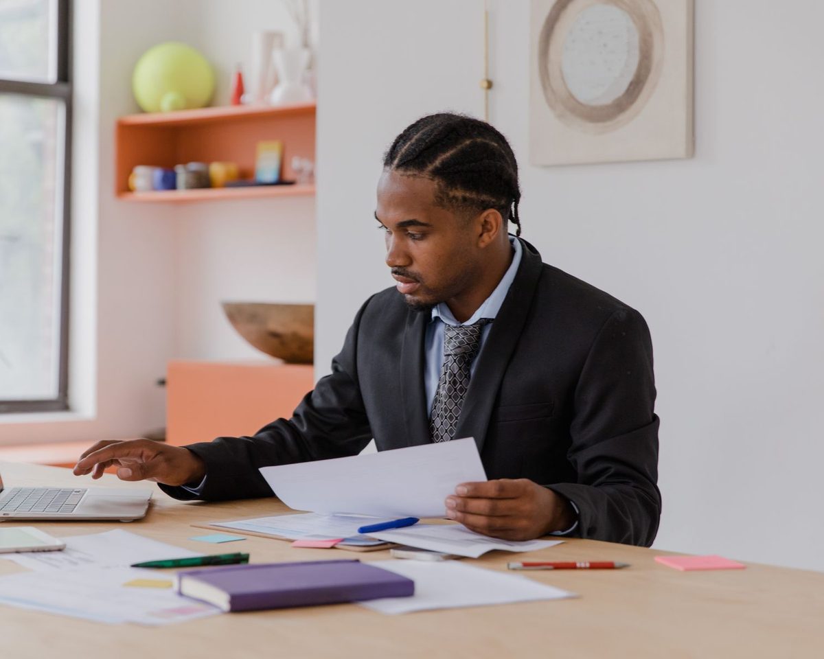 A business owner going through company paperwork at his desk