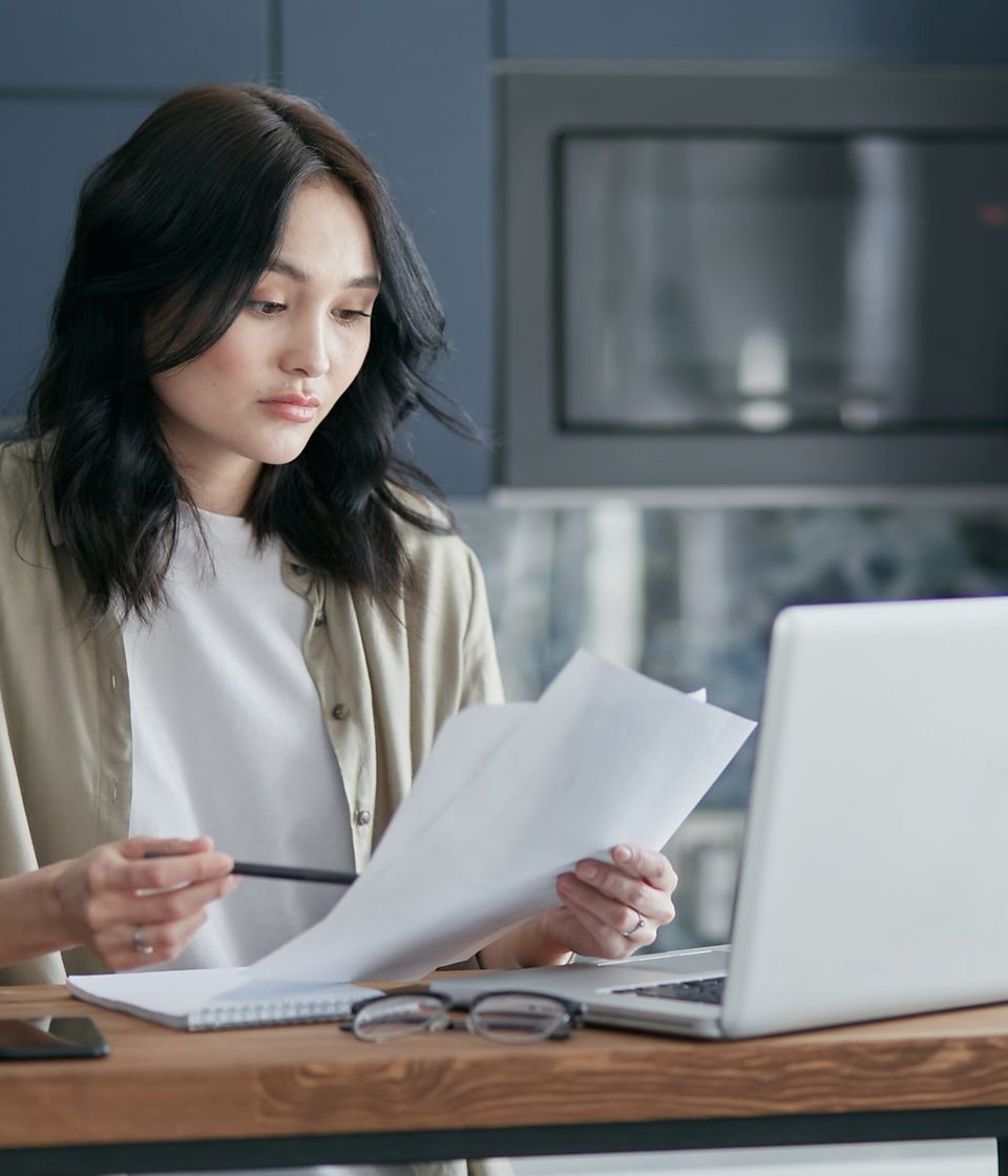A business owner reading through a contract at her desk