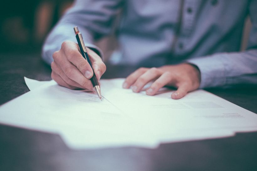 A business owner signing a contract