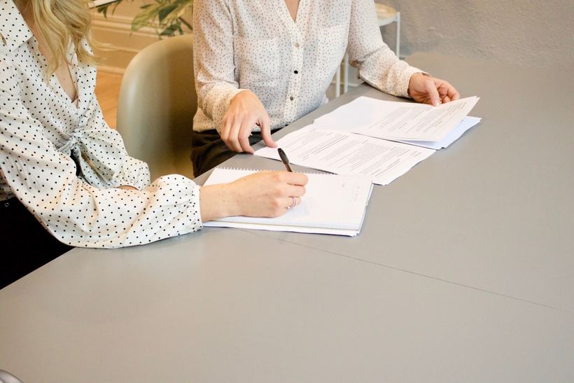 Two business partners signing an agreement
